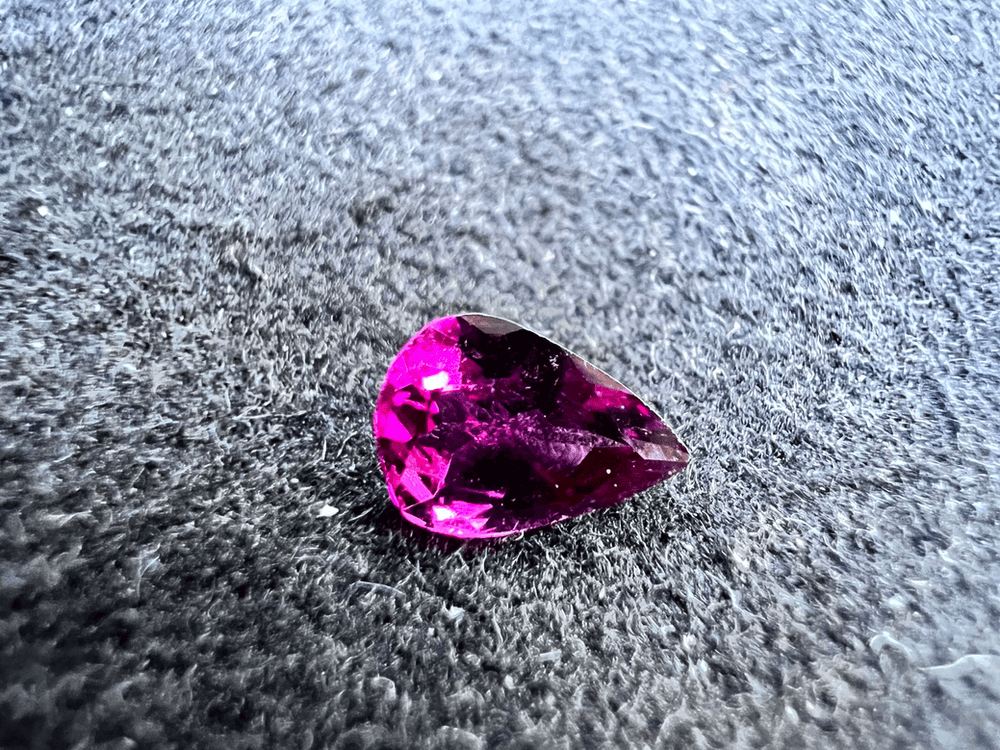 rhodolite garnet stone cut on neutral background to illustrate rhodolite garnet