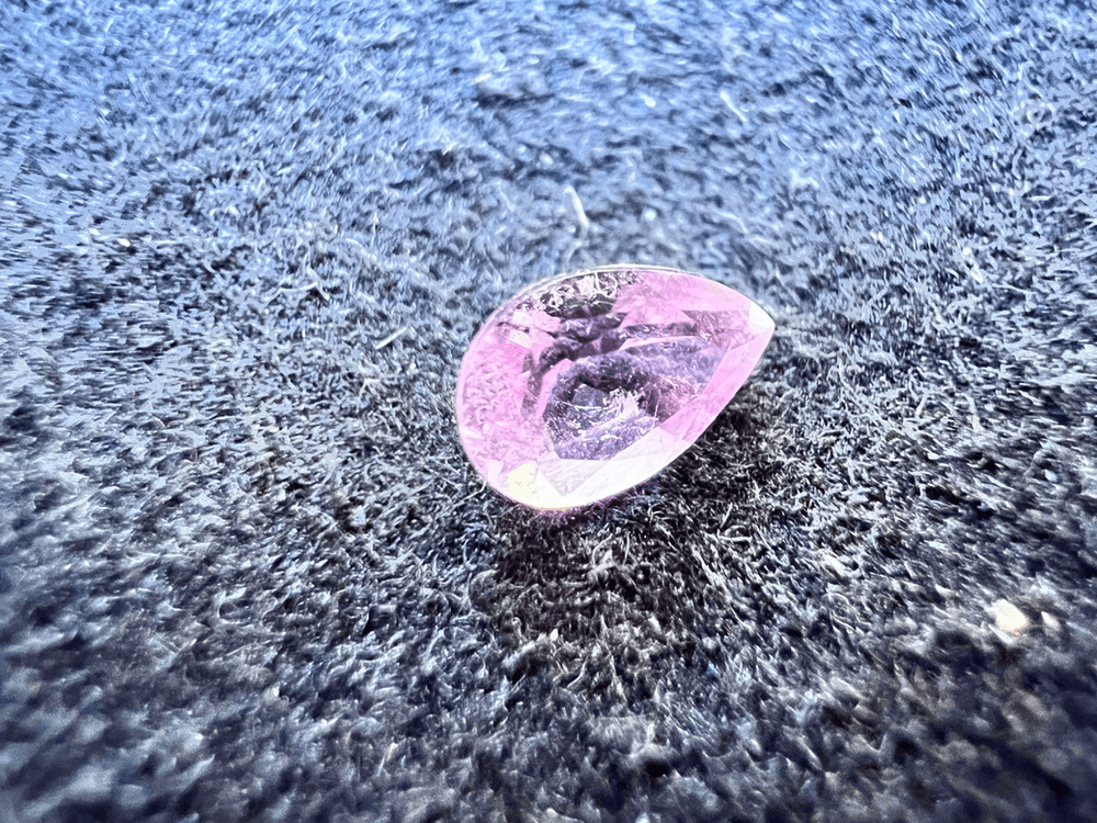 pink elbaite tourmaline stone cut on a neutral background to illustrate the tourmaline